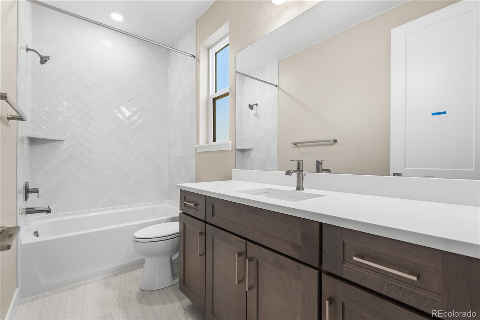 11293 Tenor Trail Lone Tree, CO 80134 - Photo 43 of 50 a bathroom with a sink a toilet and a bathtub