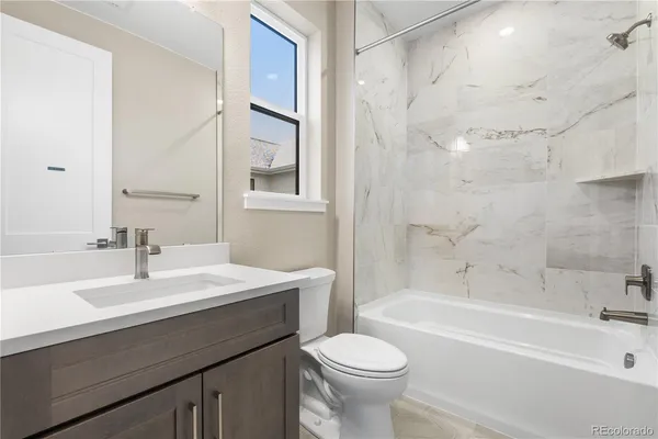 a bathroom with a sink a toilet and a bathtub