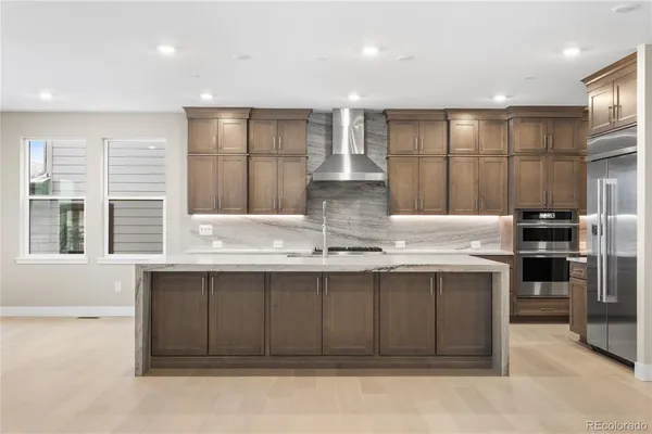 a kitchen with stainless steel appliances granite countertop a sink and cabinets