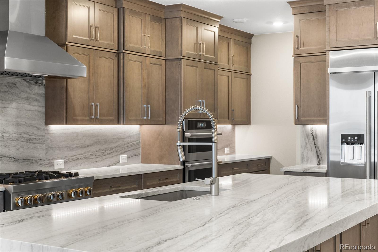 11293 Tenor Trail Lone Tree, CO 80134 - Photo 10 of 50 a kitchen with stainless steel appliances granite countertop a refrigerator and a stove