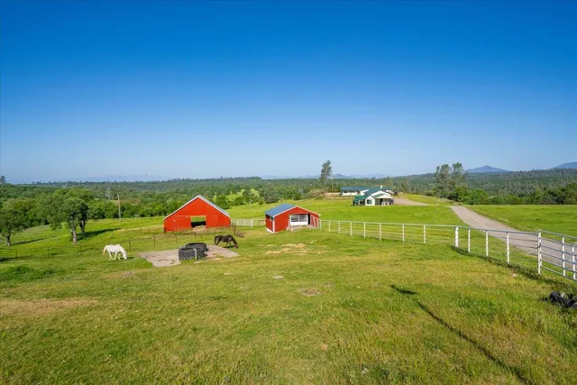 a kitchen with stainless steel appliances granite countertop a refrigerator a stove and a sink