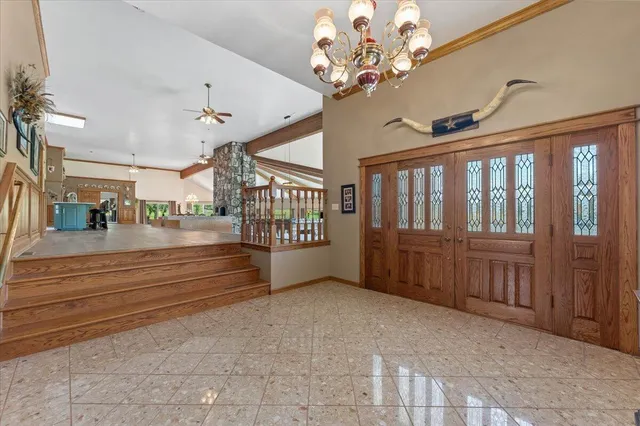 a spacious bedroom with a bed and a large window