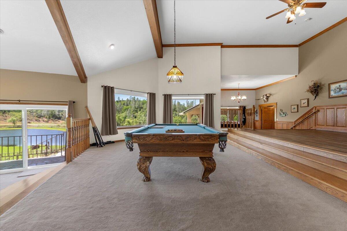 26602 Snider Ranch Road Oak Run, CA 96069 - Photo 22 of 97 a living room with furniture a flat screen tv and a large window