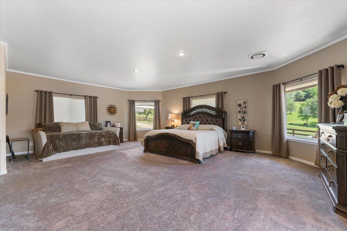 26602 Snider Ranch Road Oak Run, CA 96069 - Photo 35 of 97 a spacious bedroom with a bed and large window
