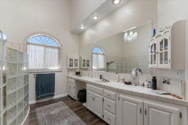 a front view of house with yard and trees in the background