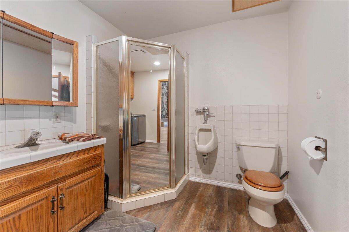26602 Snider Ranch Road Oak Run, CA 96069 - Photo 41 of 97 a bathroom with a granite countertop toilet sink and a mirror