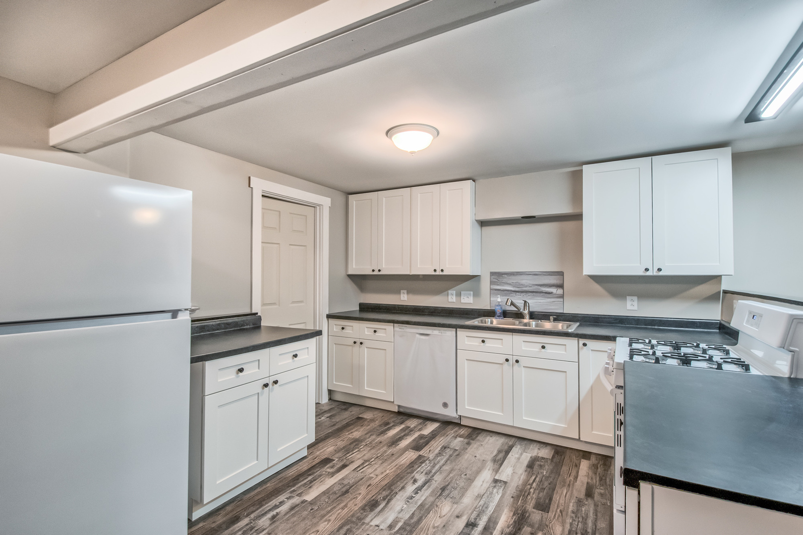 26769 North Genesee Street Wauconda, IL 60084 - Photo 6 of 16 a kitchen with granite countertop white cabinets and white appliances