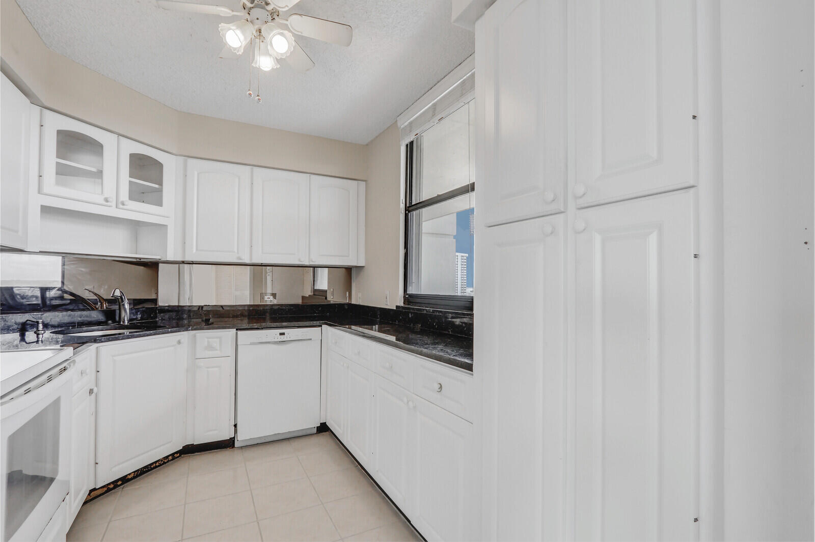 132 Lakeshore Drive, Unit 1117 North Palm Beach, FL 33408 - Photo 14 of 35 a kitchen with stainless steel appliances granite countertop a sink and a stove