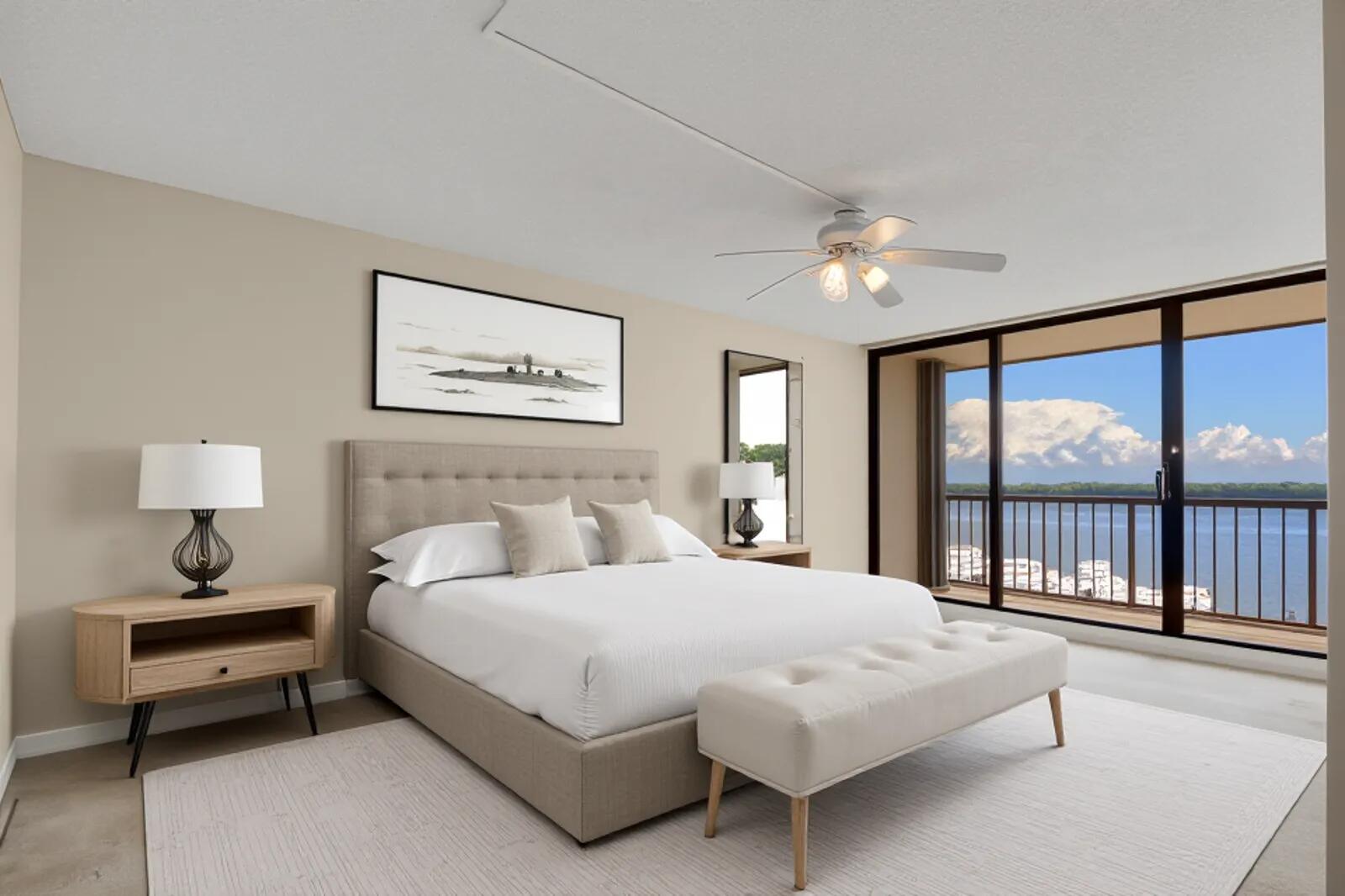 132 Lakeshore Drive, Unit 1117 North Palm Beach, FL 33408 - Photo 16 of 35 a bedroom with a large bed and a large window