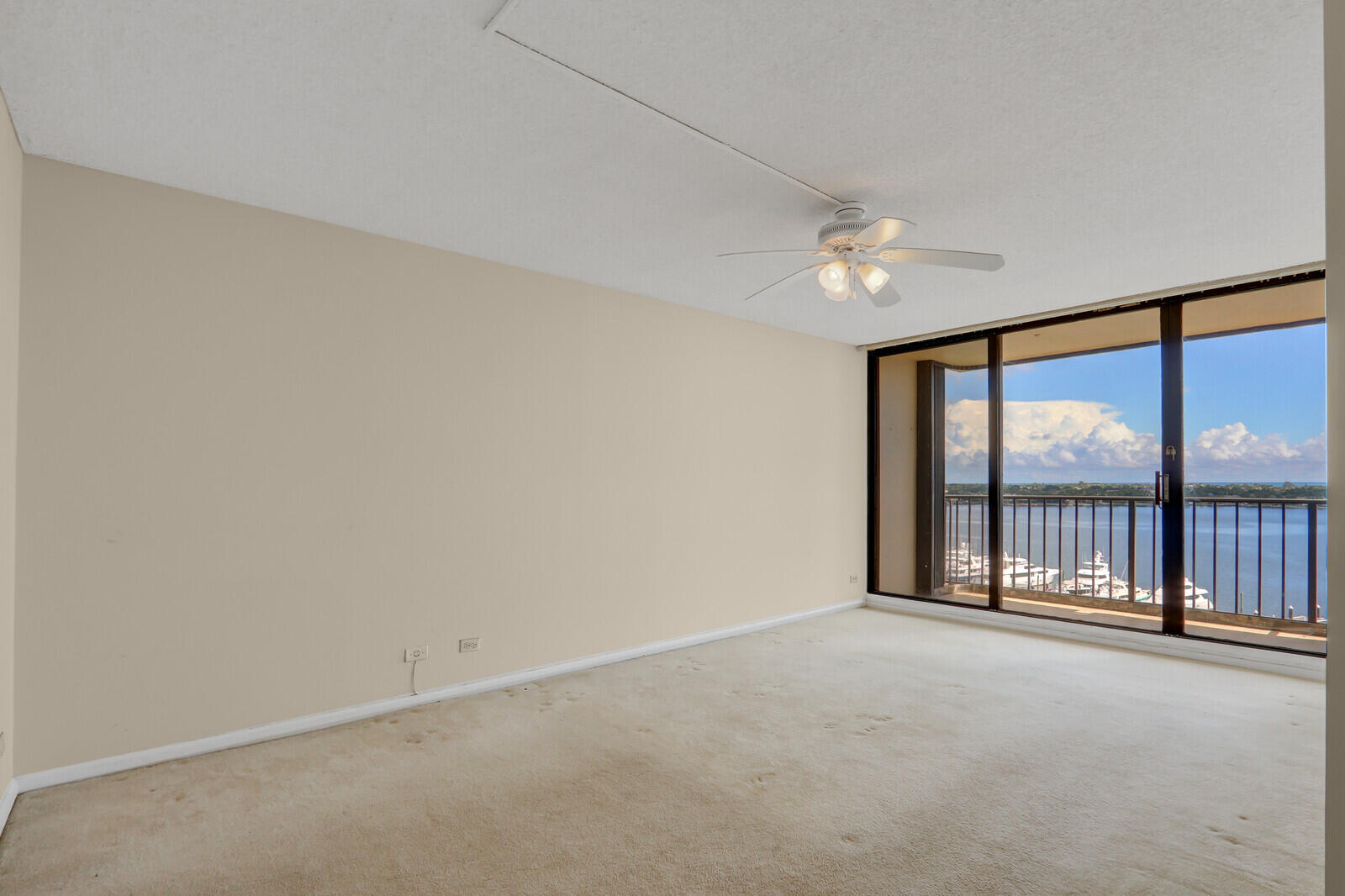 132 Lakeshore Drive, Unit 1117 North Palm Beach, FL 33408 - Photo 17 of 35 wooden floor in an empty room with a window