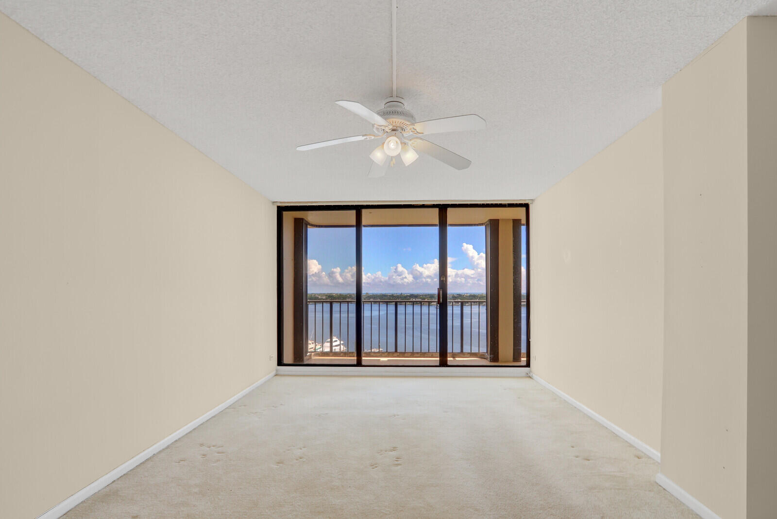 132 Lakeshore Drive, Unit 1117 North Palm Beach, FL 33408 - Photo 18 of 35 an empty room with a ceiling fan and window