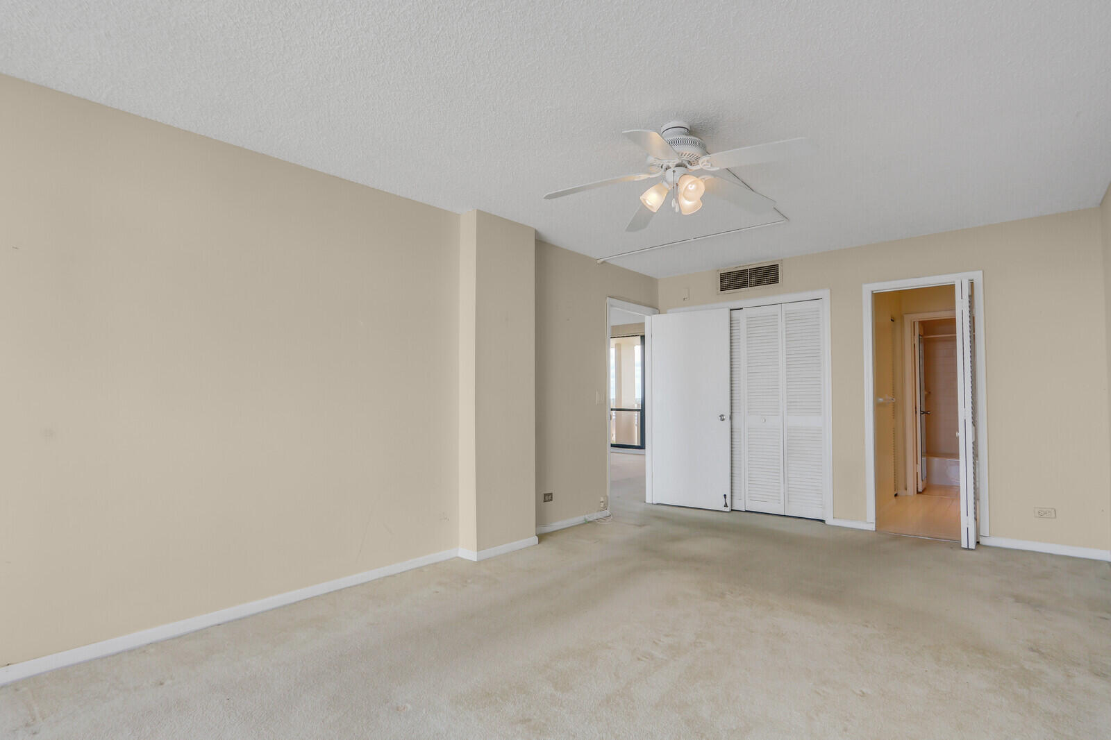 132 Lakeshore Drive, Unit 1117 North Palm Beach, FL 33408 - Photo 20 of 35 a view of an empty room and chandelier fan