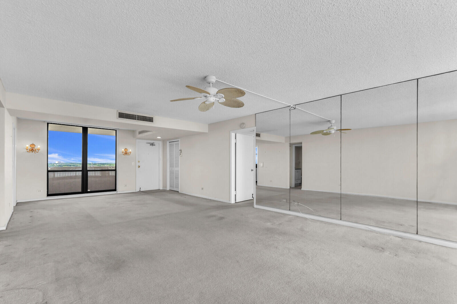 132 Lakeshore Drive, Unit 1117 North Palm Beach, FL 33408 - Photo 10 of 35 an empty room with a ceiling fan and window