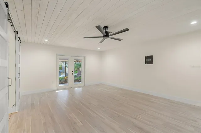 wooden floor in an empty room with a window