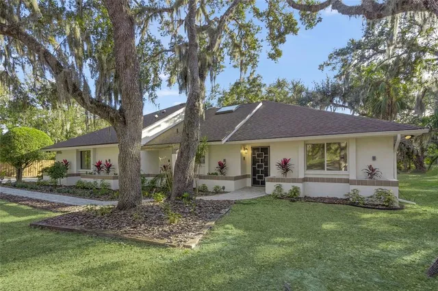 a view of a house with a yard and garage