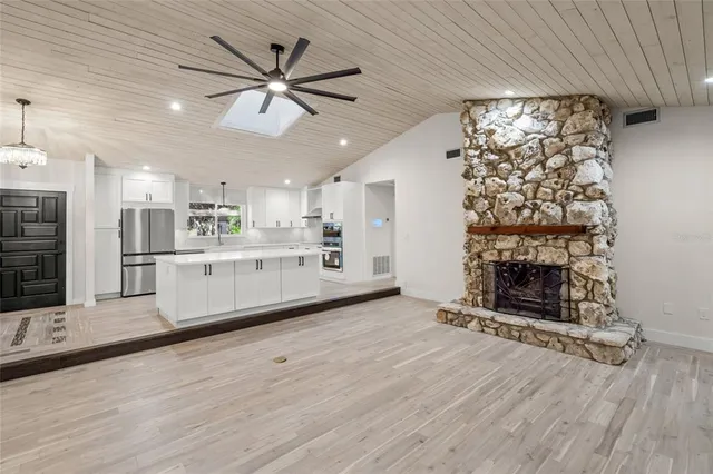 a view of a kitchen with furniture and a fireplace