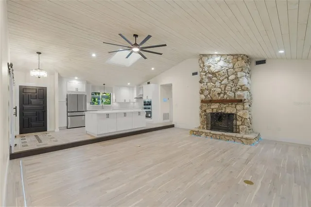wooden floor in an empty room with a fireplace