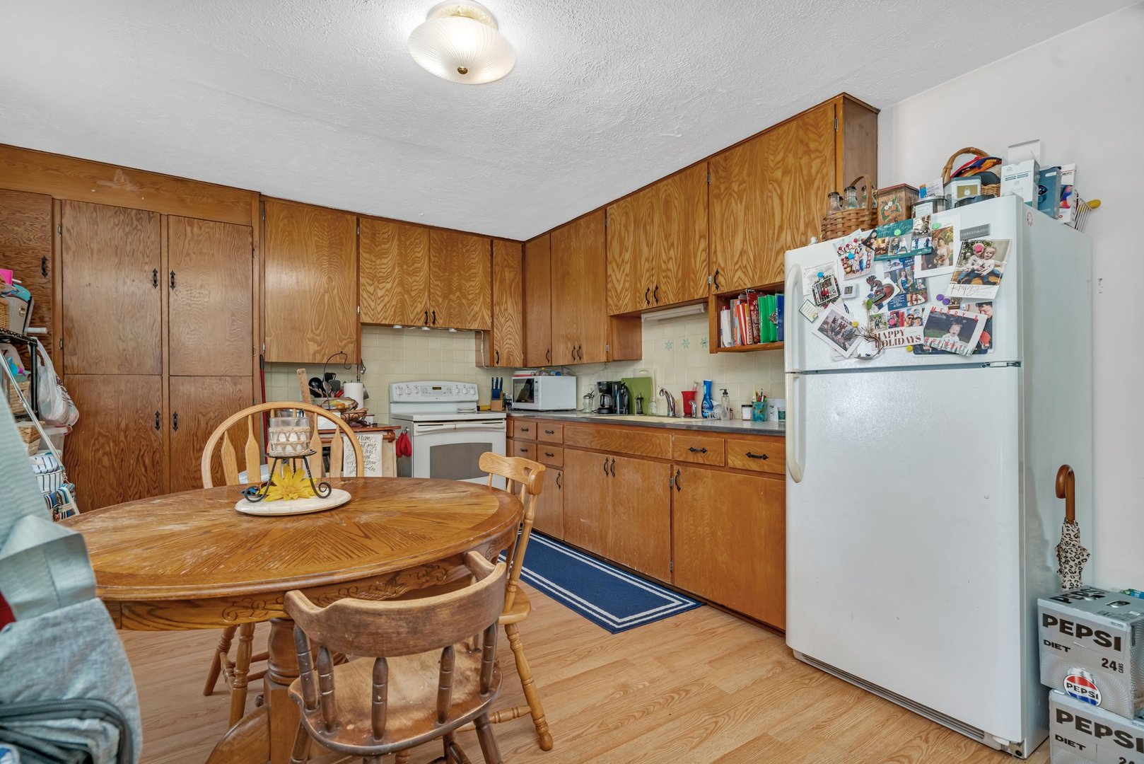 107 North Elm Street Gardner, IL 60424 - Photo 12 of 40 a kitchen with granite countertop cabinets stainless steel appliances and a refrigerator