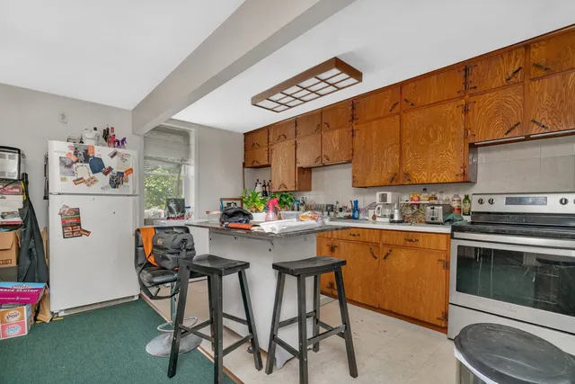 a kitchen with a table and chairs in it