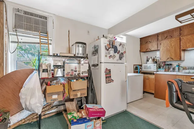 a room with stainless steel appliances kitchen island granite countertop furniture and a kitchen view