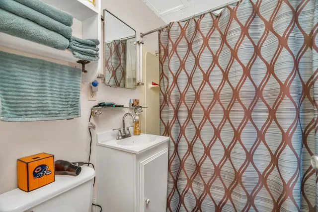 a bathroom with a sink and a shower curtain