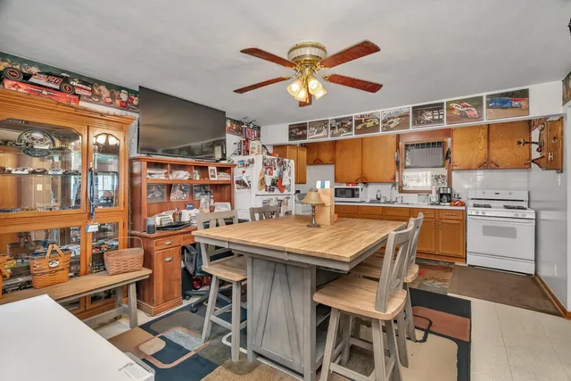a dining table with chairs and window