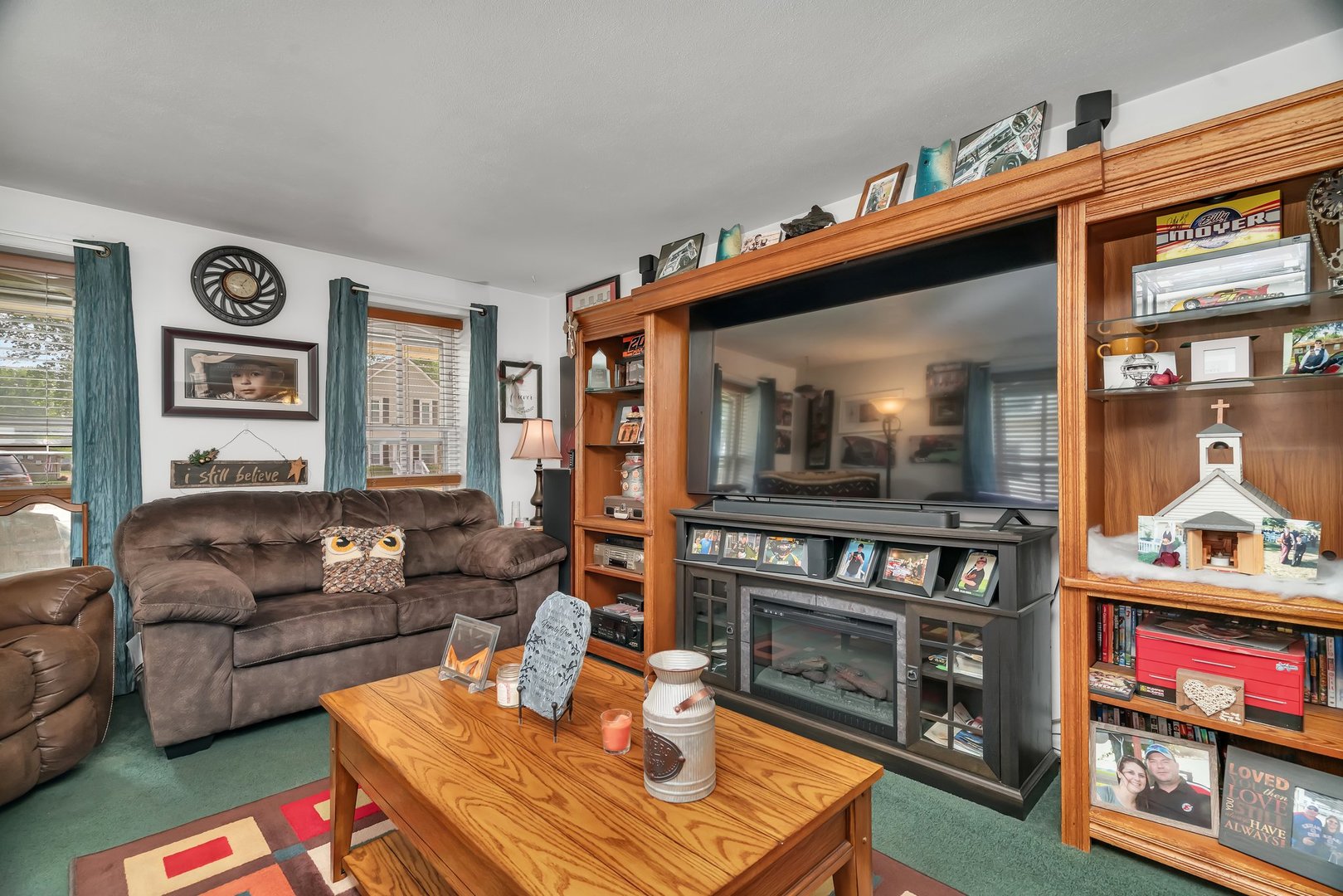 107 North Elm Street Gardner, IL 60424 - Photo 37 of 40 a living room with furniture a flat screen tv and a fireplace