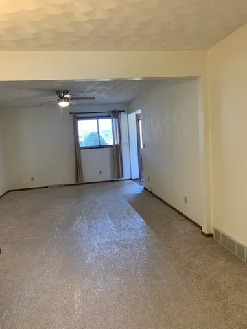 a kitchen with a sink cabinets and wooden floor