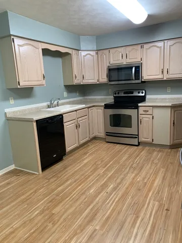 a view of an empty room with wooden shelves