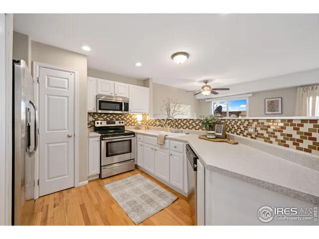a kitchen with granite countertop a sink stove and refrigerator