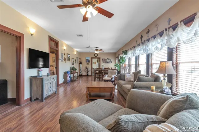 a living room with fireplace furniture and a flat screen tv
