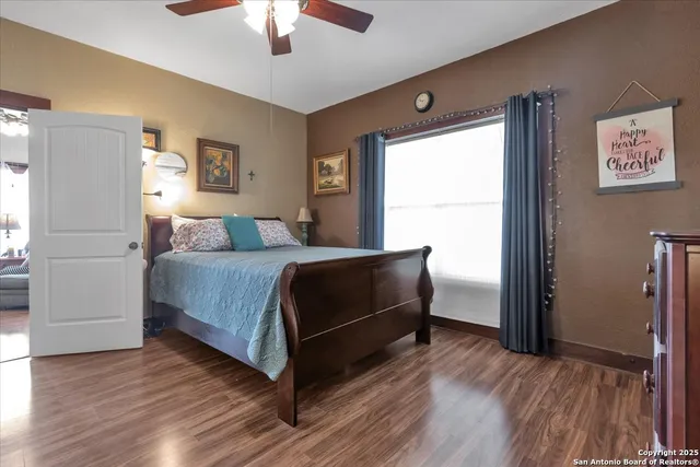 a spacious bathroom with a granite countertop sink a mirror and a bathtub