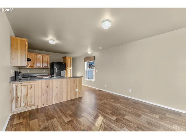 a kitchen with stainless steel appliances a refrigerator sink and white cabinets