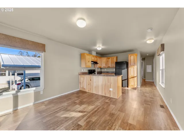a view of a kitchen with wooden floor