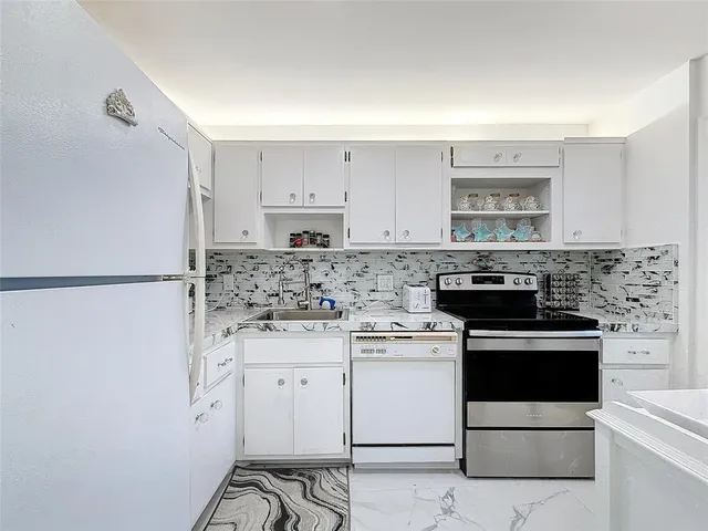 a kitchen with a stove top oven and cabinets