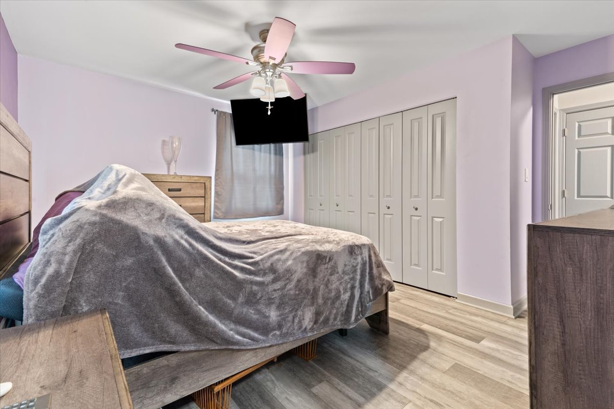 1011 Aspen Drive Buffalo Grove, IL 60089 - Photo 11 of 19 a bedroom with a bed and a chandelier