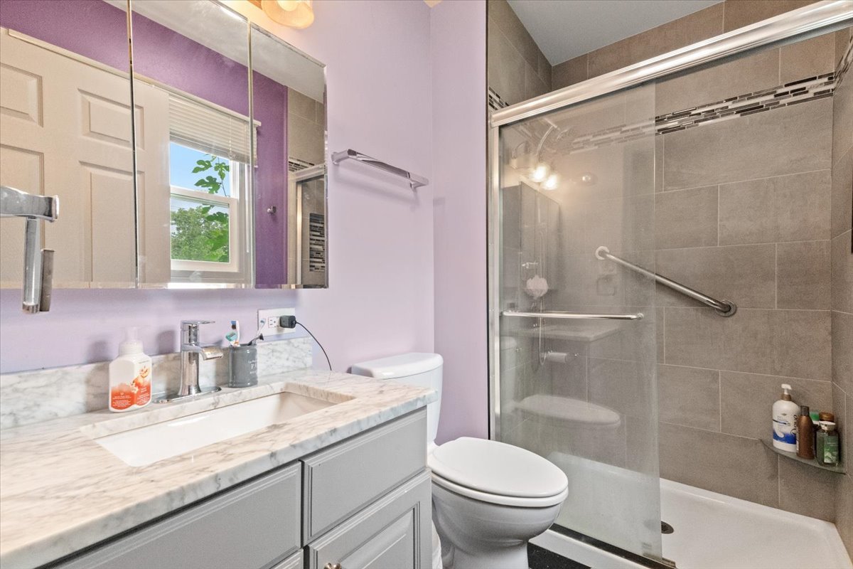 1011 Aspen Drive Buffalo Grove, IL 60089 - Photo 12 of 19 a bathroom with a granite countertop sink toilet and shower