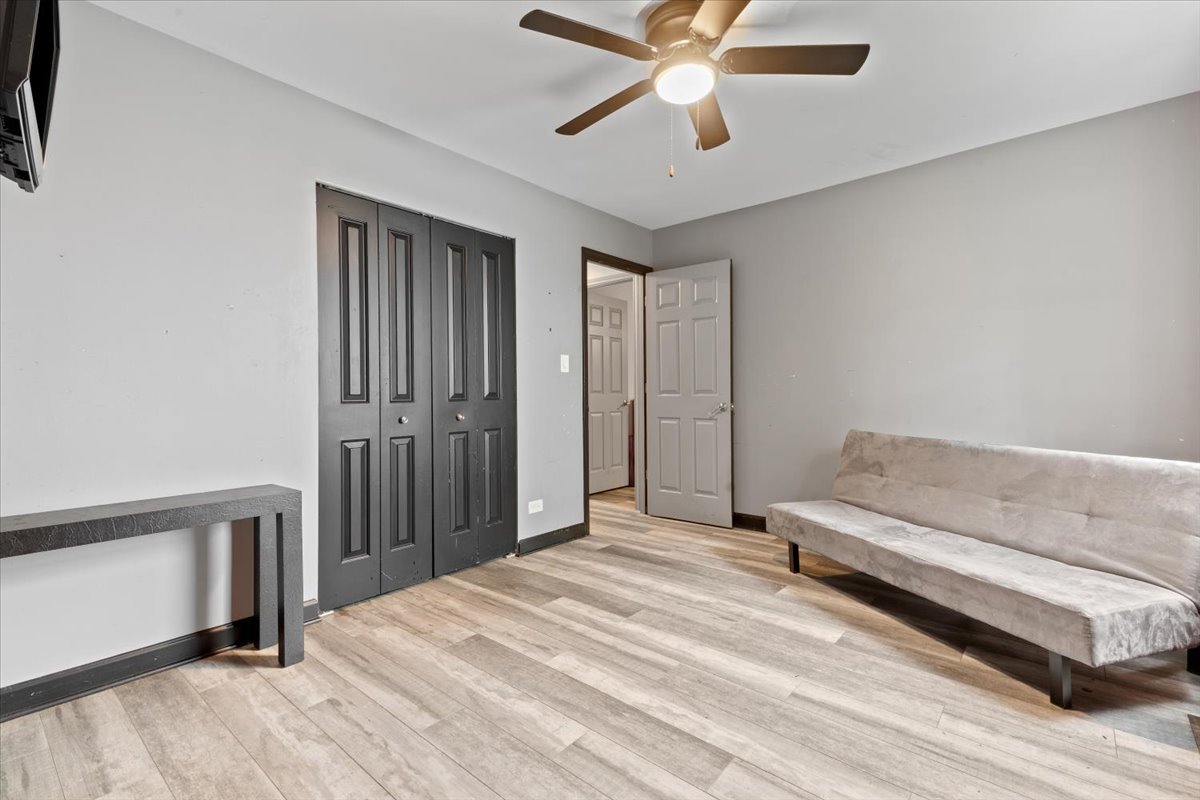 1011 Aspen Drive Buffalo Grove, IL 60089 - Photo 13 of 19 a bedroom with a bed and a chandelier