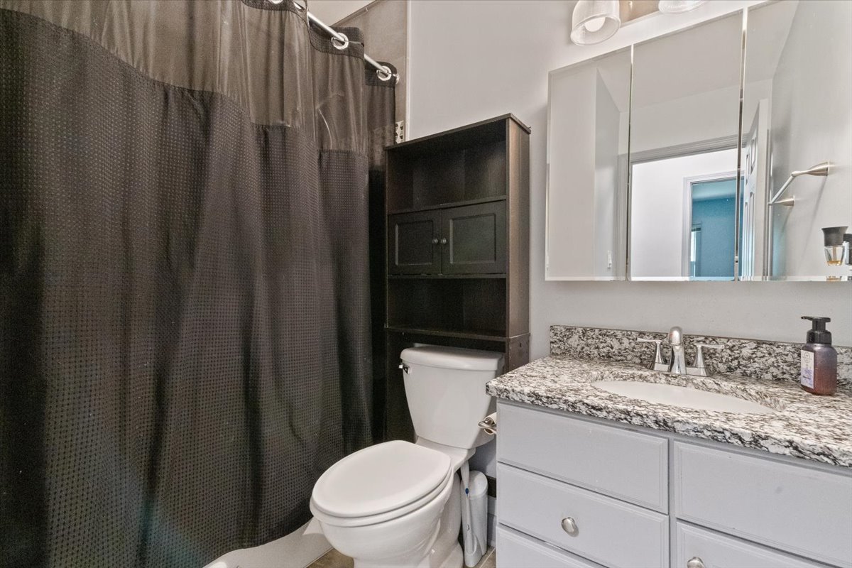 1011 Aspen Drive Buffalo Grove, IL 60089 - Photo 15 of 19 a bathroom with a granite countertop toilet sink and a mirror