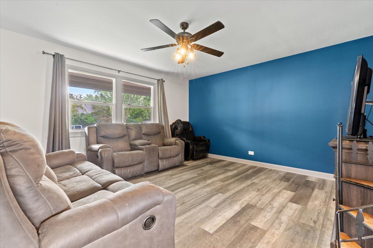 1011 Aspen Drive Buffalo Grove, IL 60089 - Photo 3 of 19 a living room with furniture and a large window with a flat screen tv