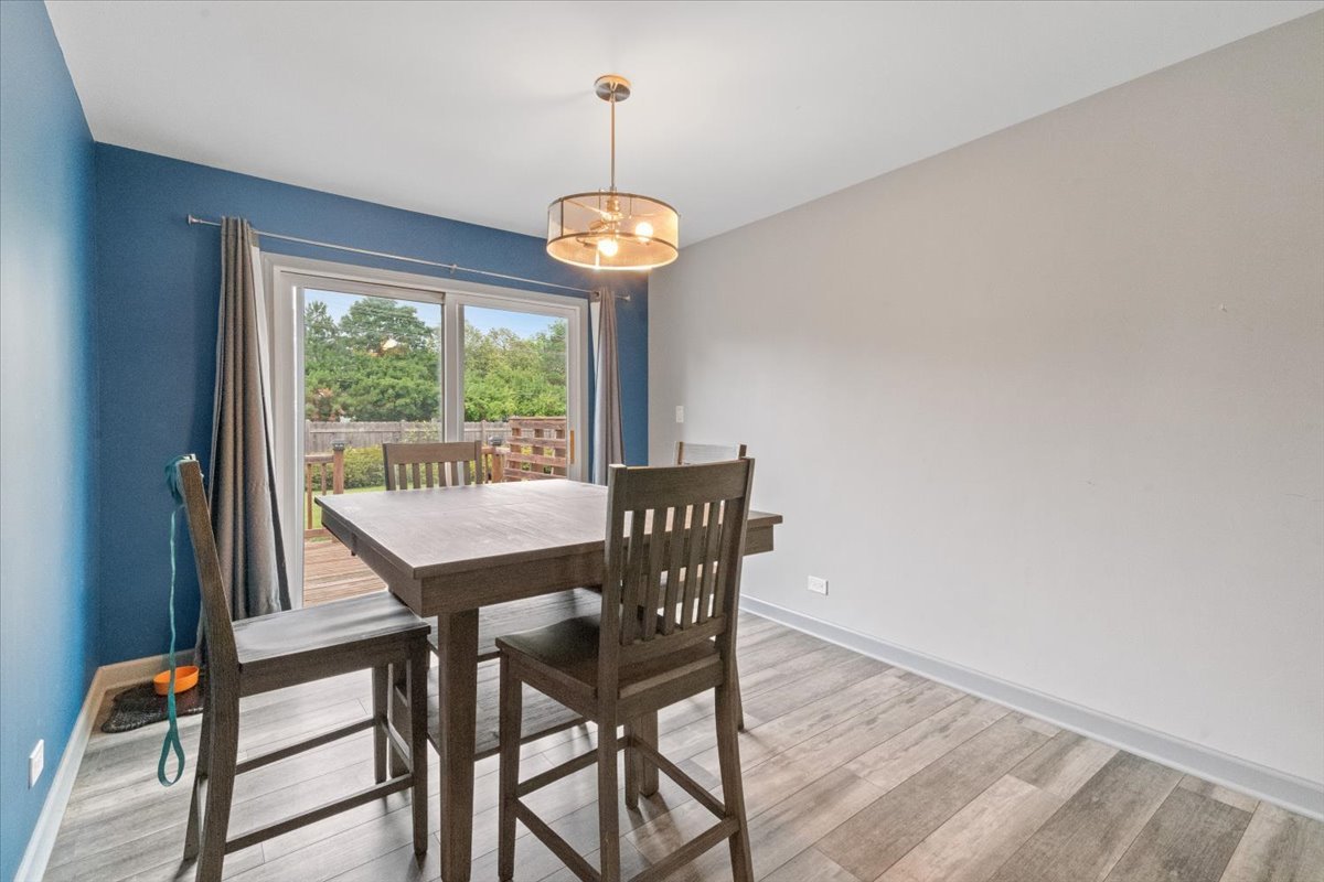 1011 Aspen Drive Buffalo Grove, IL 60089 - Photo 7 of 19 a view of a dining room with furniture wooden floor and chandelier