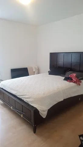 a bedroom with a bed and dresser