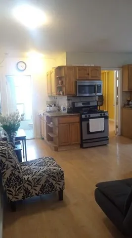 a living room with furniture and a kitchen