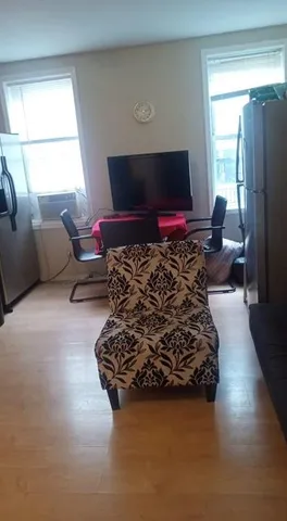 a living room with furniture gym equipment and a flat screen tv