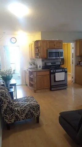 a living room with furniture and a kitchen