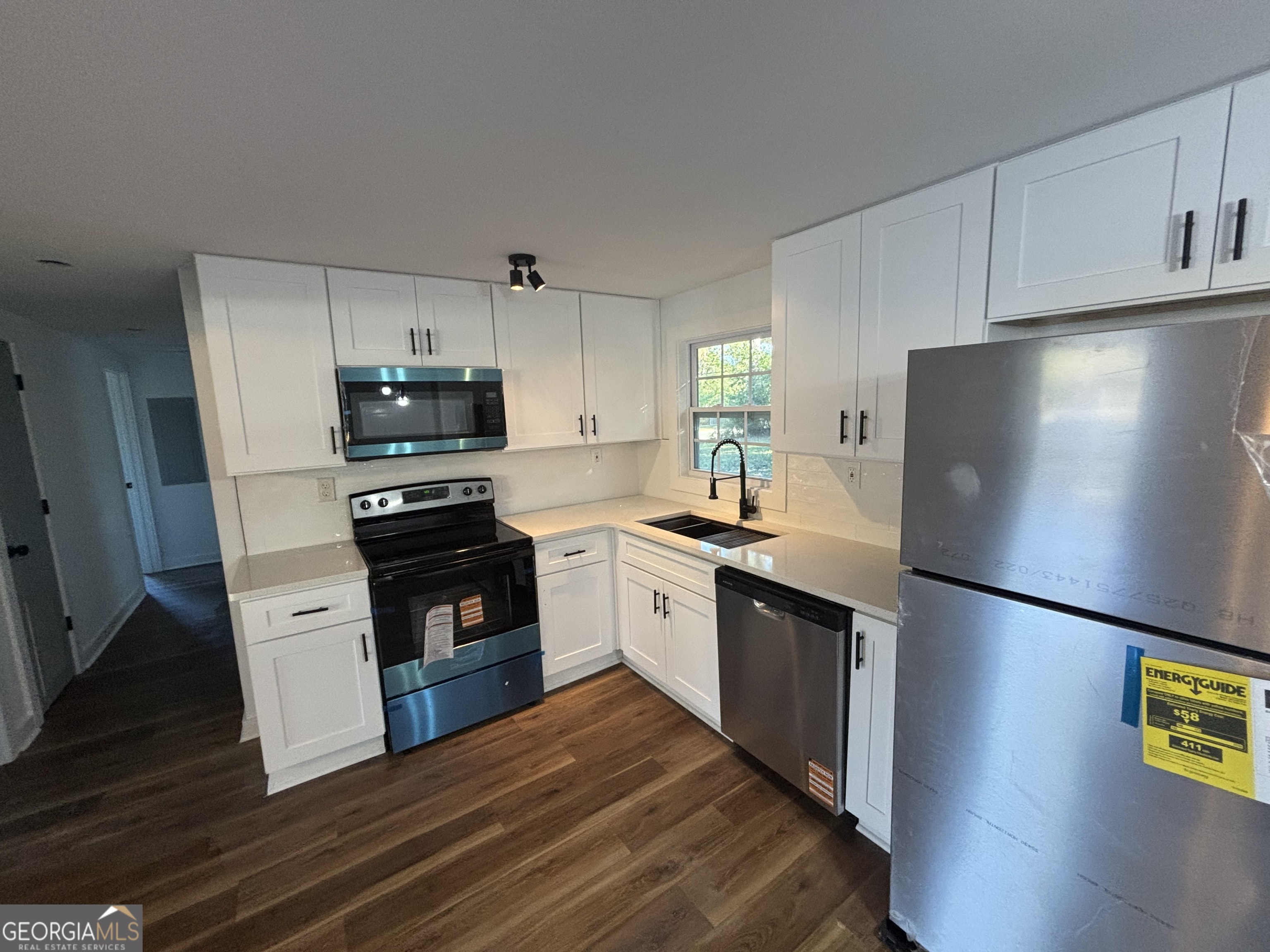 176 Randall Avenue Flovilla, GA 30216 - Photo 12 of 32 a kitchen with stainless steel appliances a refrigerator sink and microwave