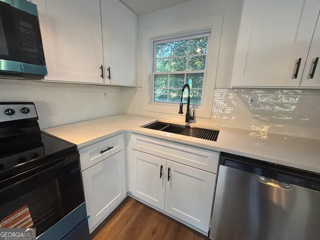 a kitchen with a sink stove and cabinets