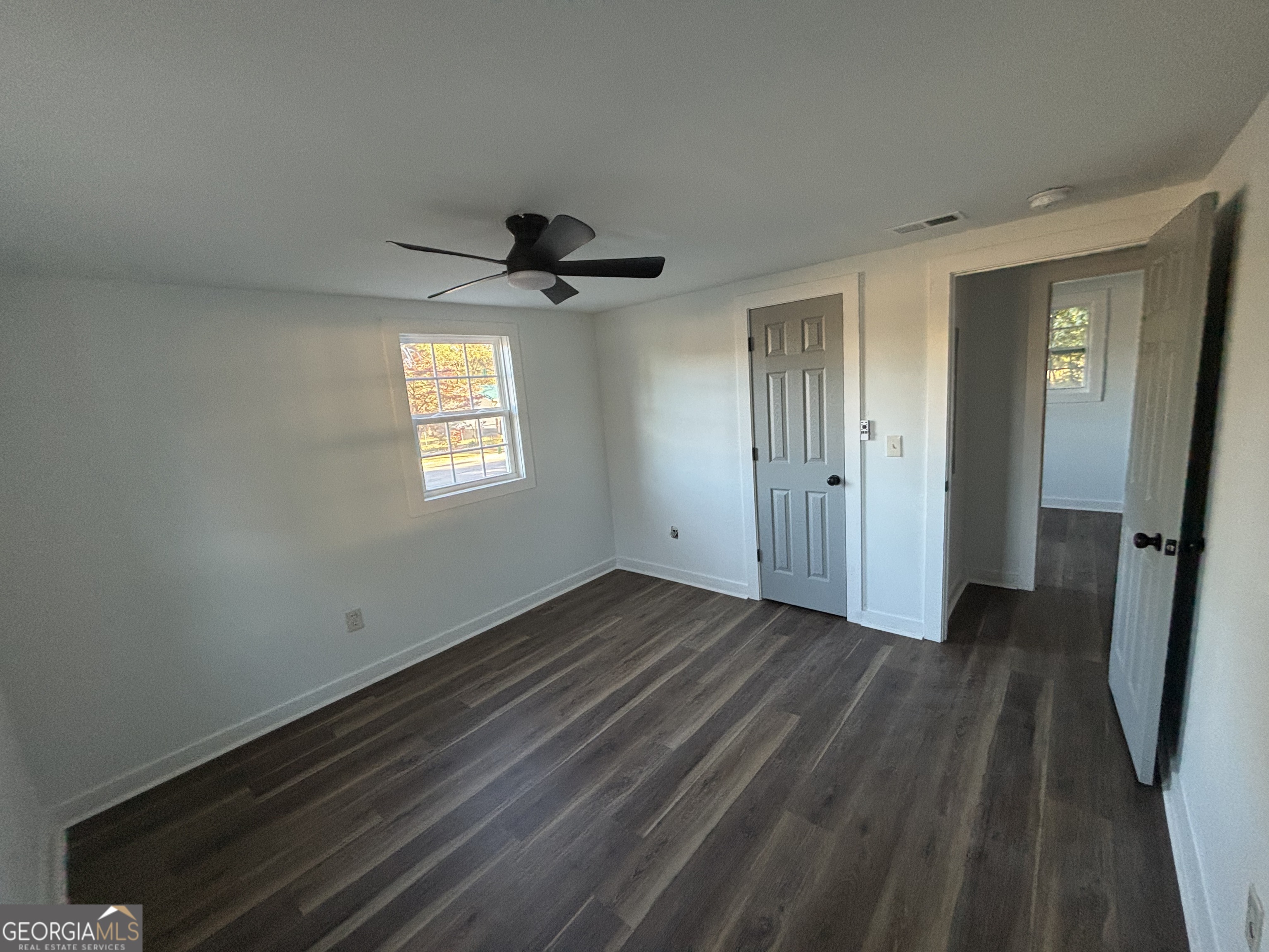 176 Randall Avenue Flovilla, GA 30216 - Photo 19 of 32 wooden floor in an empty room with a window