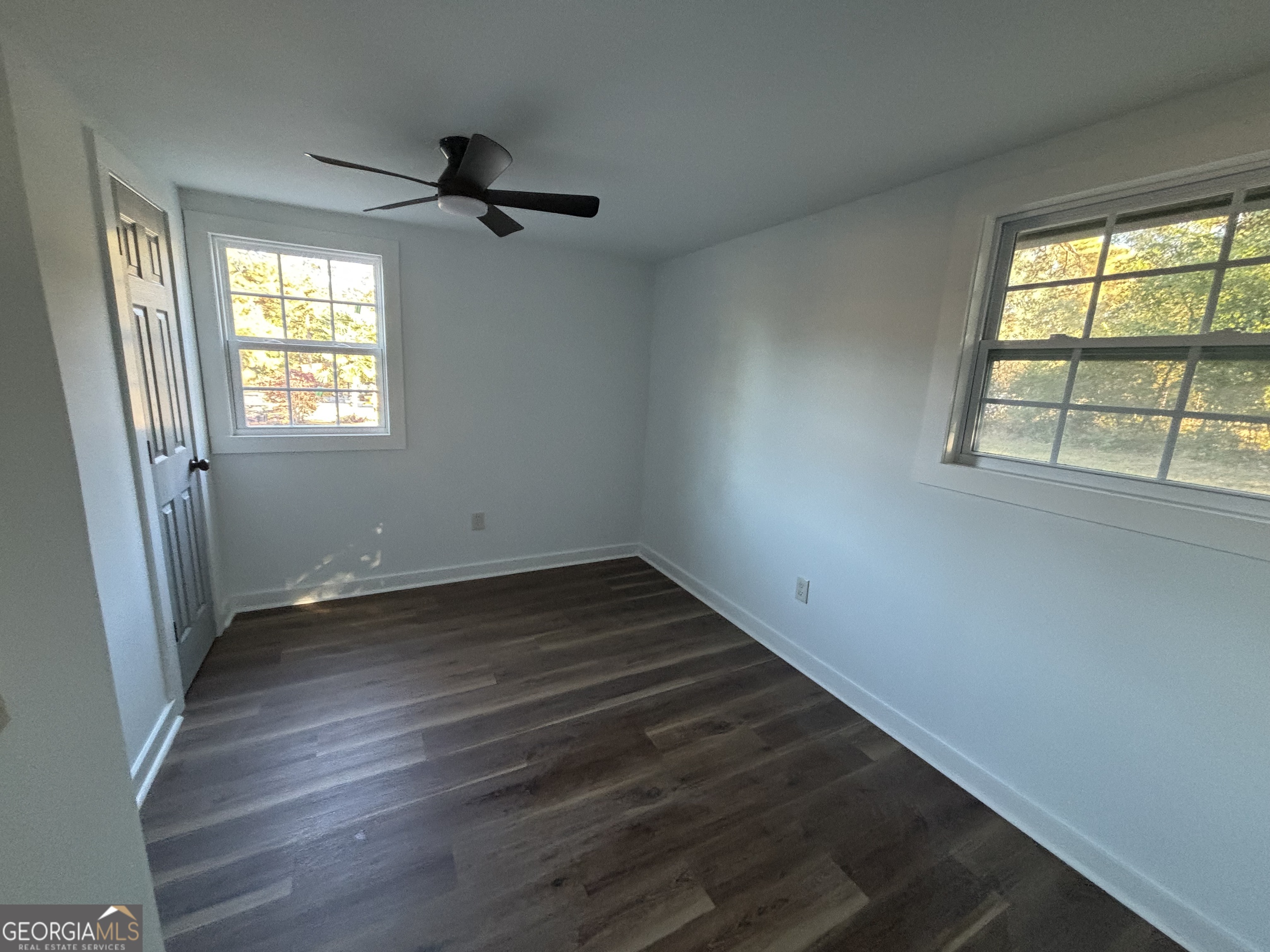 176 Randall Avenue Flovilla, GA 30216 - Photo 22 of 32 an empty room with wooden floor and windows