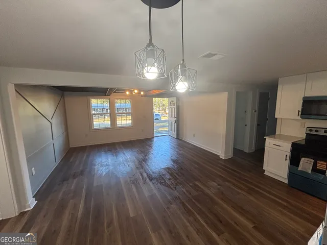a view of wooden floor and windows in an empty room